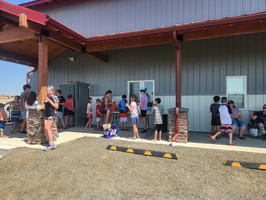 Youth and families gathered near a refreshment table