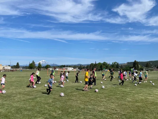 Youth playing soccer during camp